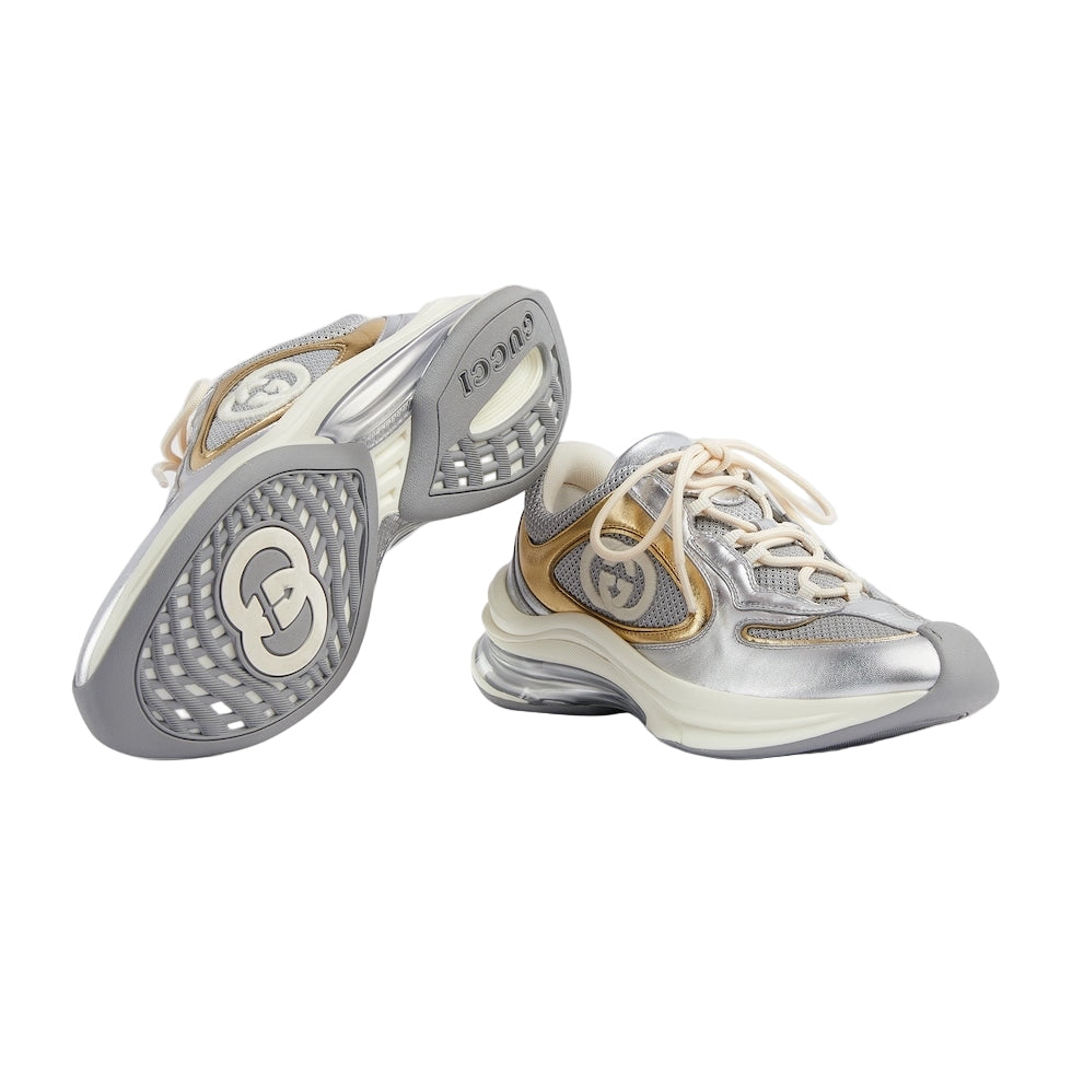 Silver and gold sneakers on a light gray background