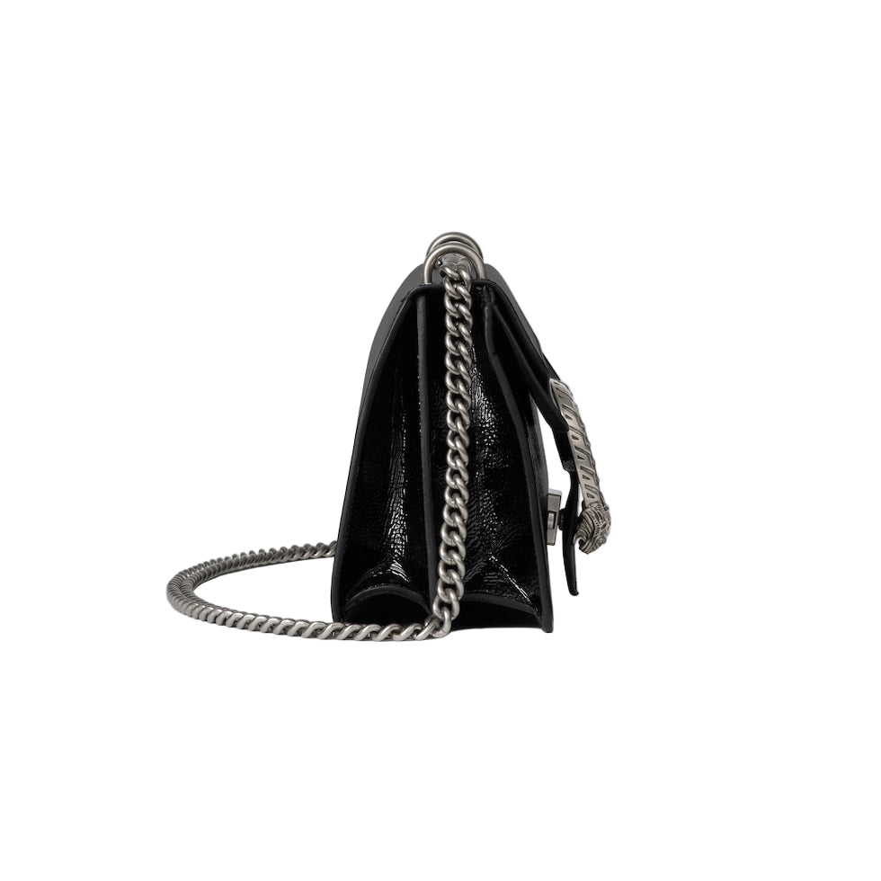 Black handbag with a chain strap on a light gray background