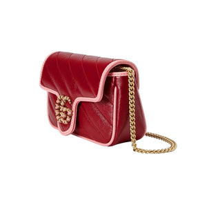 Red handbag with gold chain on a light gray background