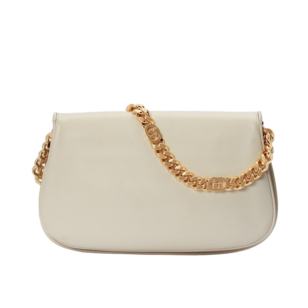 Beige handbag with a gold chain strap on a light gray background