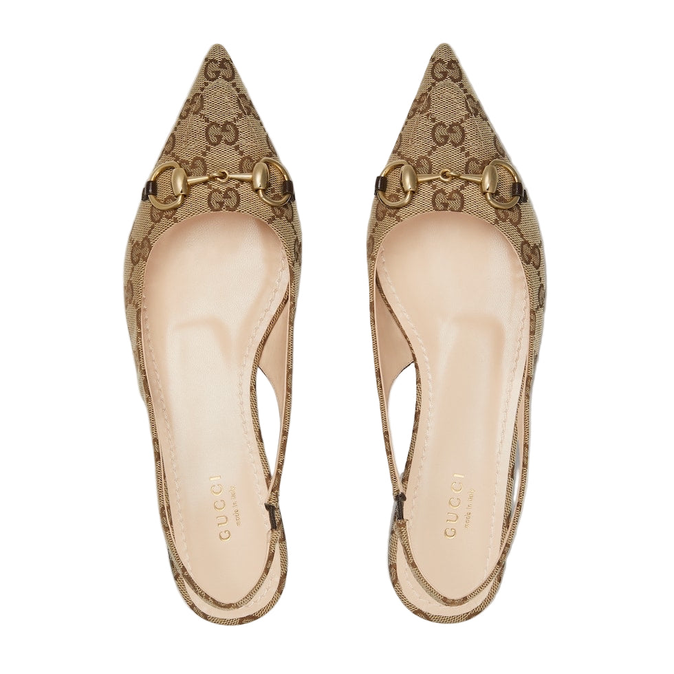 Pair of Gucci shoes with logo on a light gray background