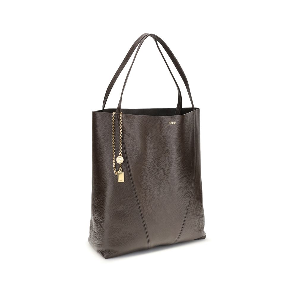 Brown leather tote bag with gold chain detail on a white background