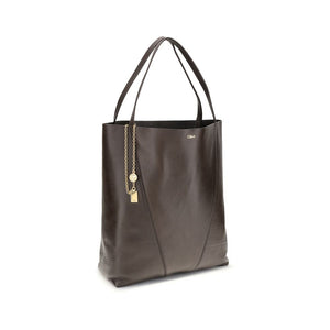 Brown leather tote bag with gold chain detail on a white background