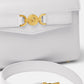 White handbag with gold accents on a white background