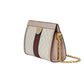 Designer handbag with chain strap on a light gray background