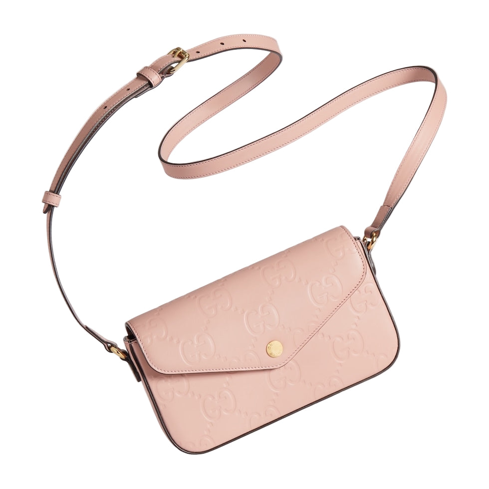 Pink handbag with a strap on a light gray background