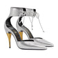 Silver high-heeled shoes with gold accents on a light gray background
