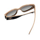 Chanel sunglasses with beige frame and black accents on a white background