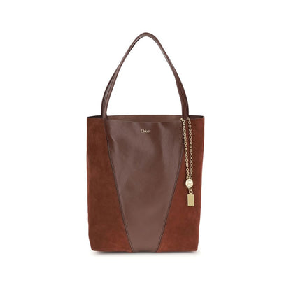 Brown leather tote bag with gold chain detail on a white background