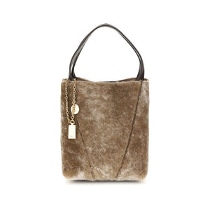 Brown fur handbag with gold chain and tag on a white background