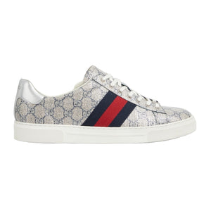 Sneaker with patterned upper and red and blue striped sole on a light gray background