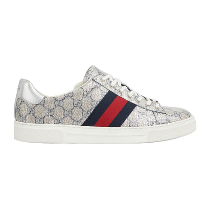 Sneaker with patterned upper and red and blue striped sole on a light gray background