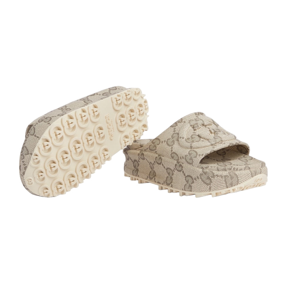 Beige slide sandals with a patterned design on a light gray background