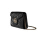 Black quilted handbag with gold chain on a light gray background