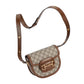 Designer handbag with brown leather strap and gold hardware on a light gray background