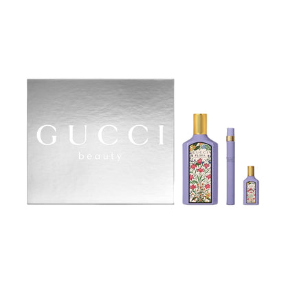 Gucci beauty products including a bottle and a smaller container on a light gray background.