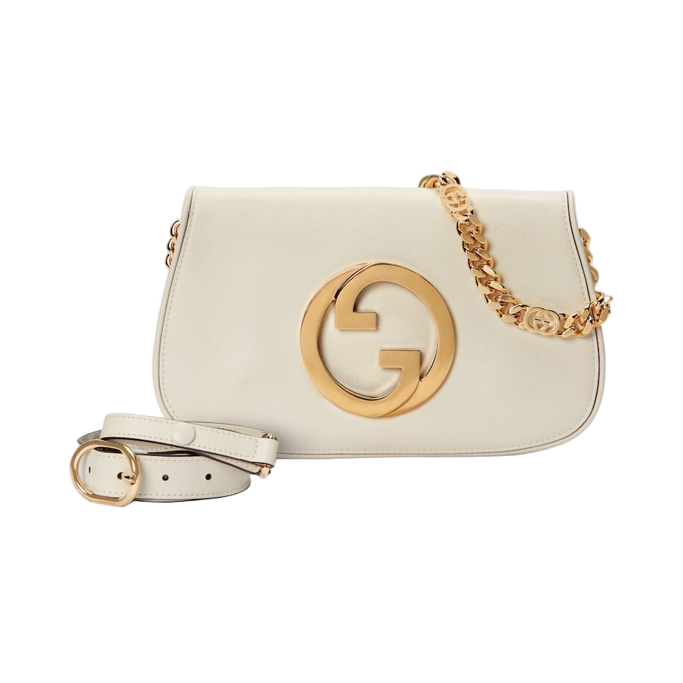 White handbag with gold chain and logo on a light gray background
