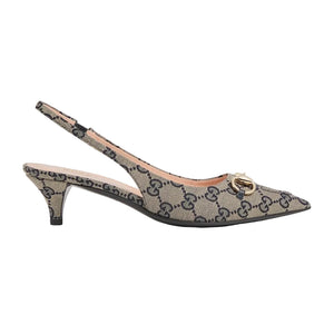 High-heeled shoe with Gucci logo on a light gray background