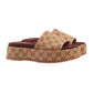 Beige and brown patterned slide sandals on a light gray background