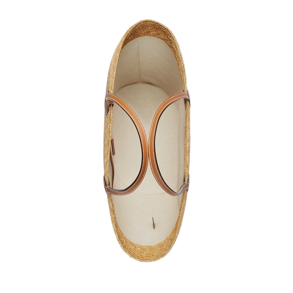 Woven sandal with tan strap on a light gray background