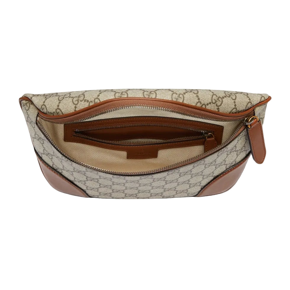 Designer handbag with patterned fabric and brown accents on a light gray background