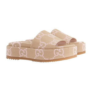 Beige platform sandals with a pattern on a light gray background