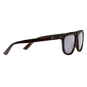 Sunglasses with tortoiseshell frame and reflective lenses on a light gray background