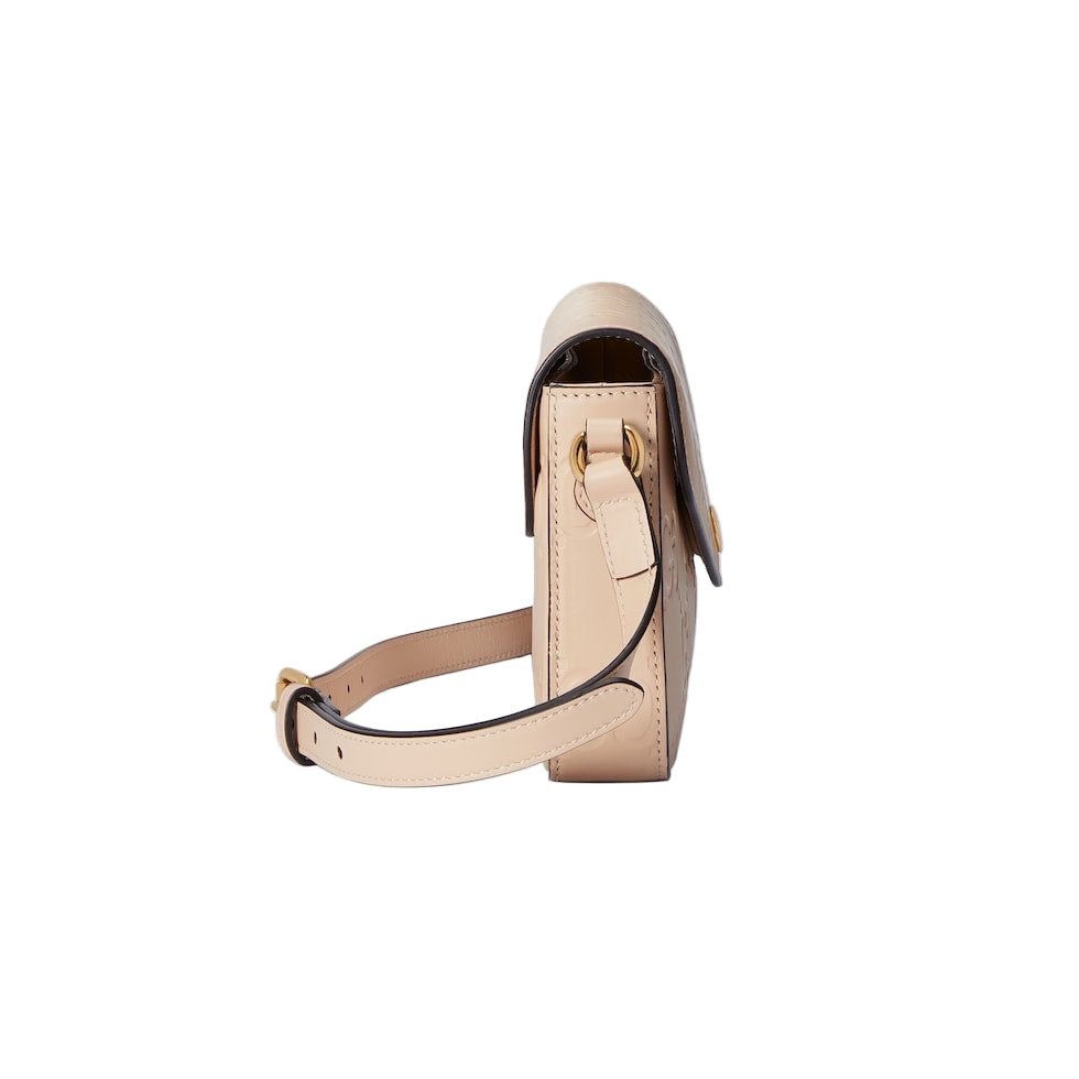Beige handbag with a strap on a light gray background