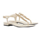 Pair of white sandals with gold chain detail on a light gray background