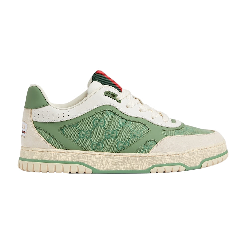 Green and white sneaker with Gucci logo on a light gray background