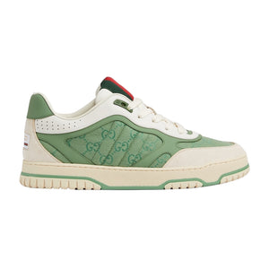 Green and white sneaker with Gucci logo on a light gray background
