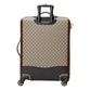 Patterned suitcase with black accents on a light gray background
