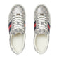 Pair of Gucci sneakers with distinctive pattern and color accents on a light gray background
