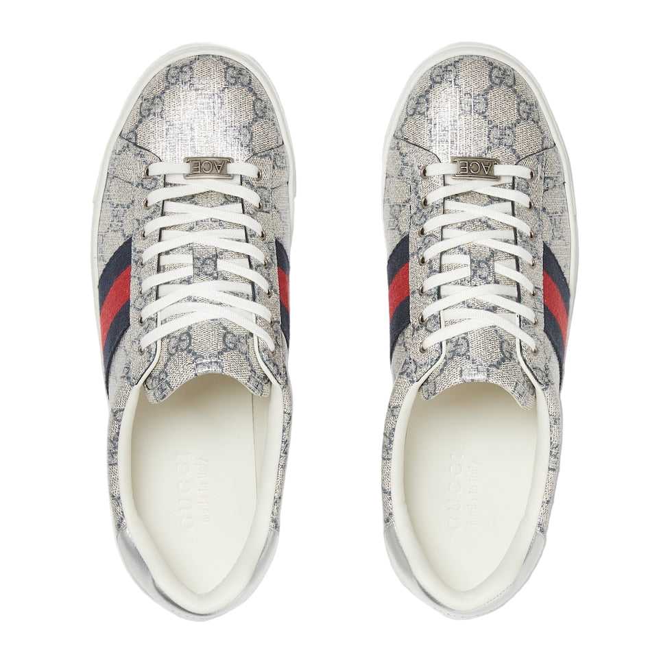 Pair of Gucci sneakers with distinctive pattern and color accents on a light gray background