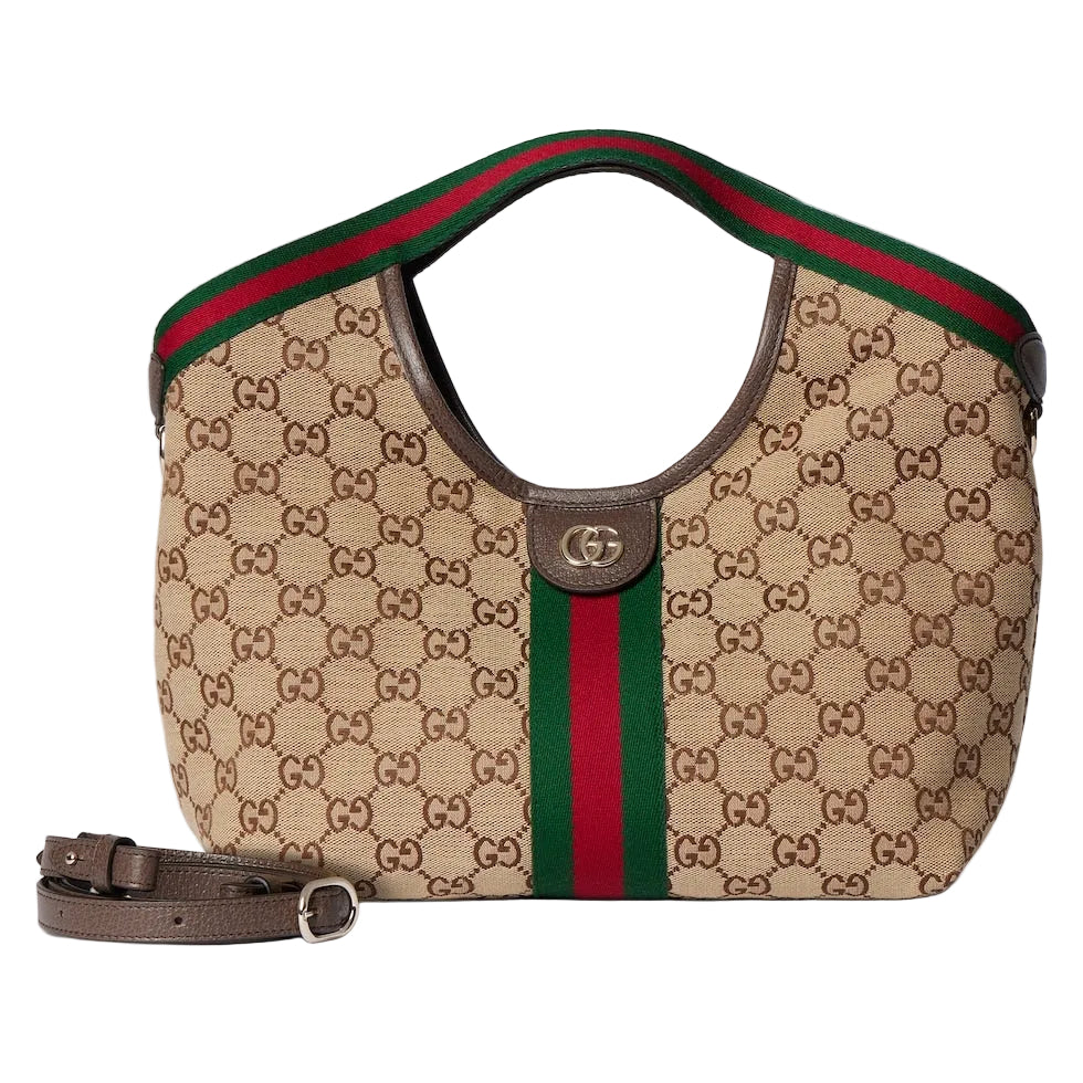 Designer handbag with monogram pattern and red and green stripe on a light gray background