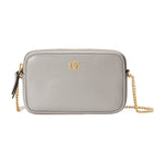 Gray handbag with gold chain and logo on a light gray background
