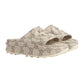 Beige slide sandals with a pattern on a light gray background