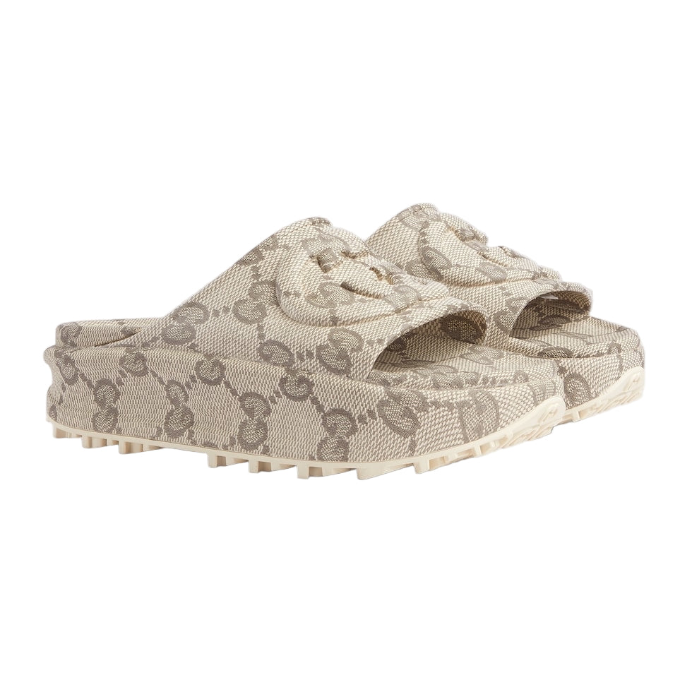 Beige slide sandals with a pattern on a light gray background