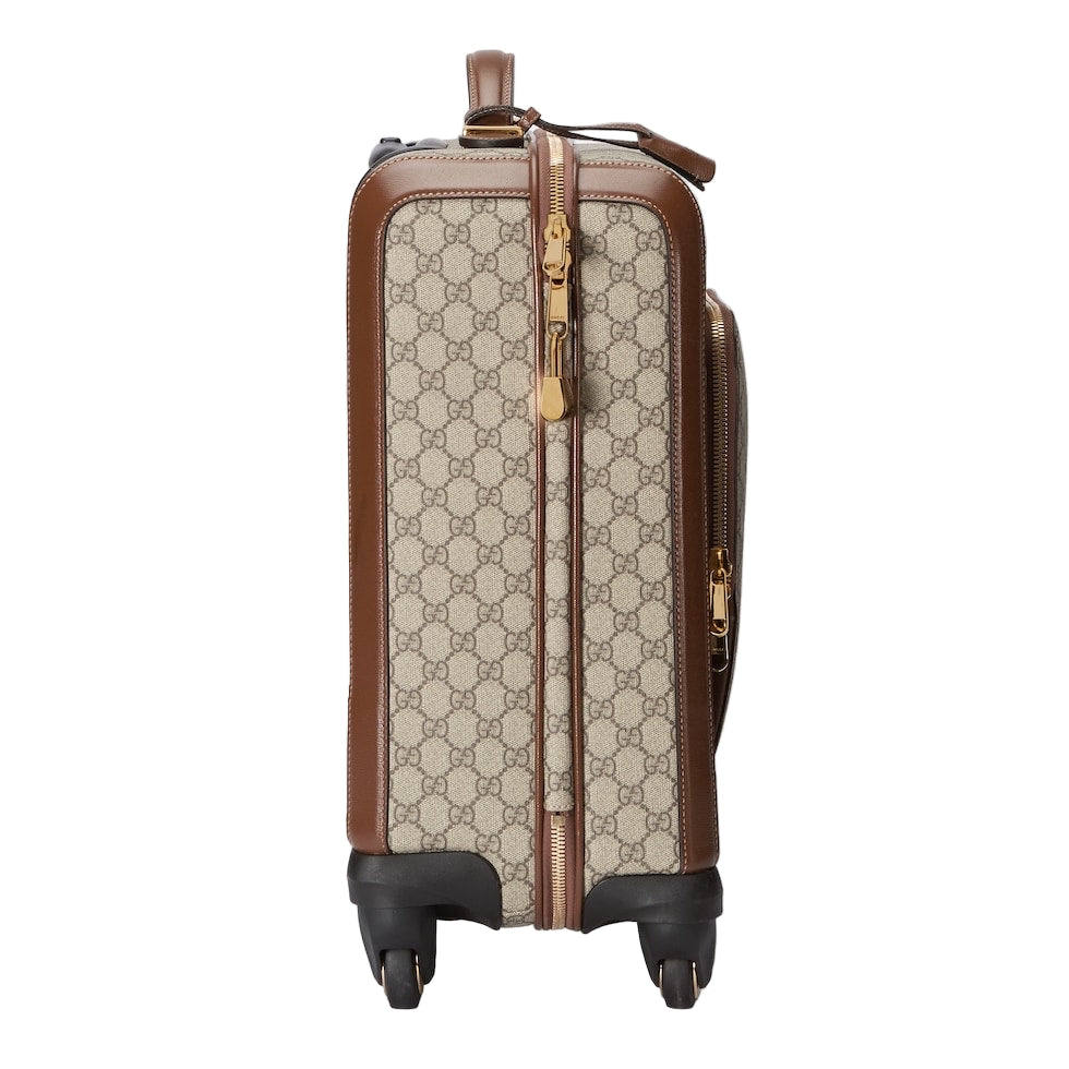 Patterned suitcase with brown accents on a light gray background