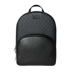 Black backpack with patterned top section on a light gray background