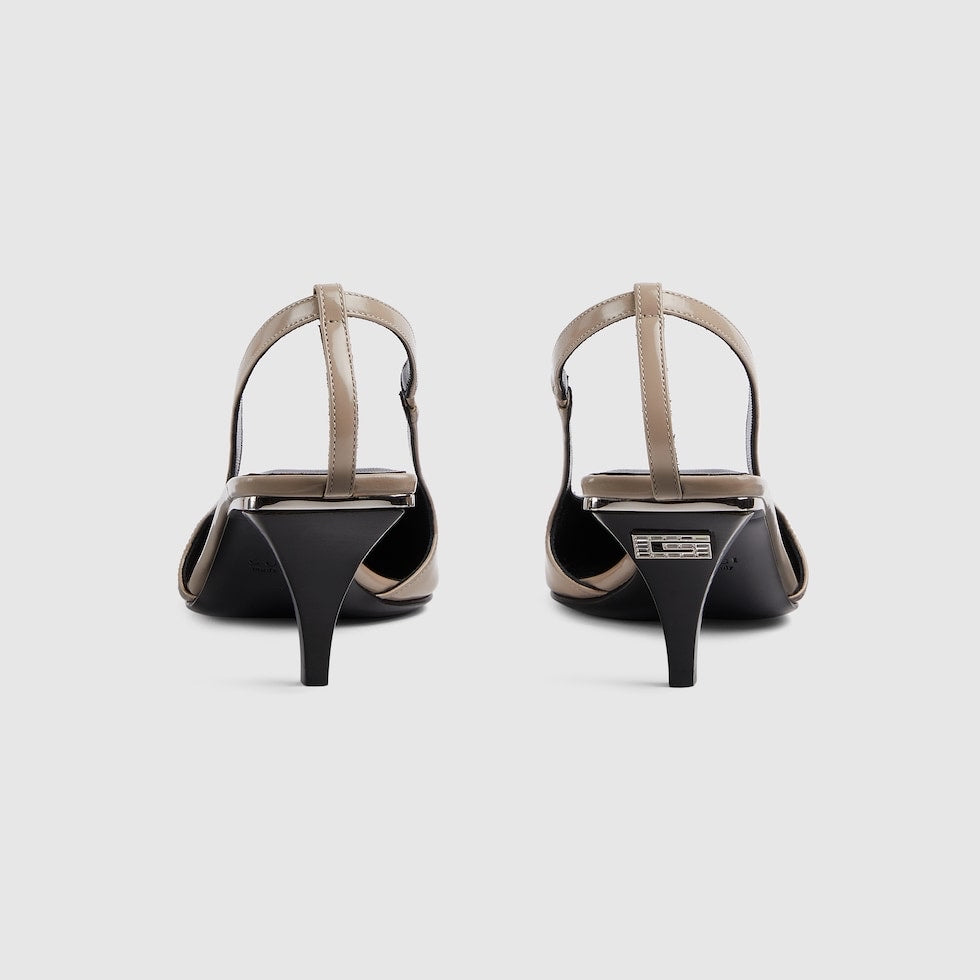 Pair of high-heeled shoes with a thin strap on a light gray background