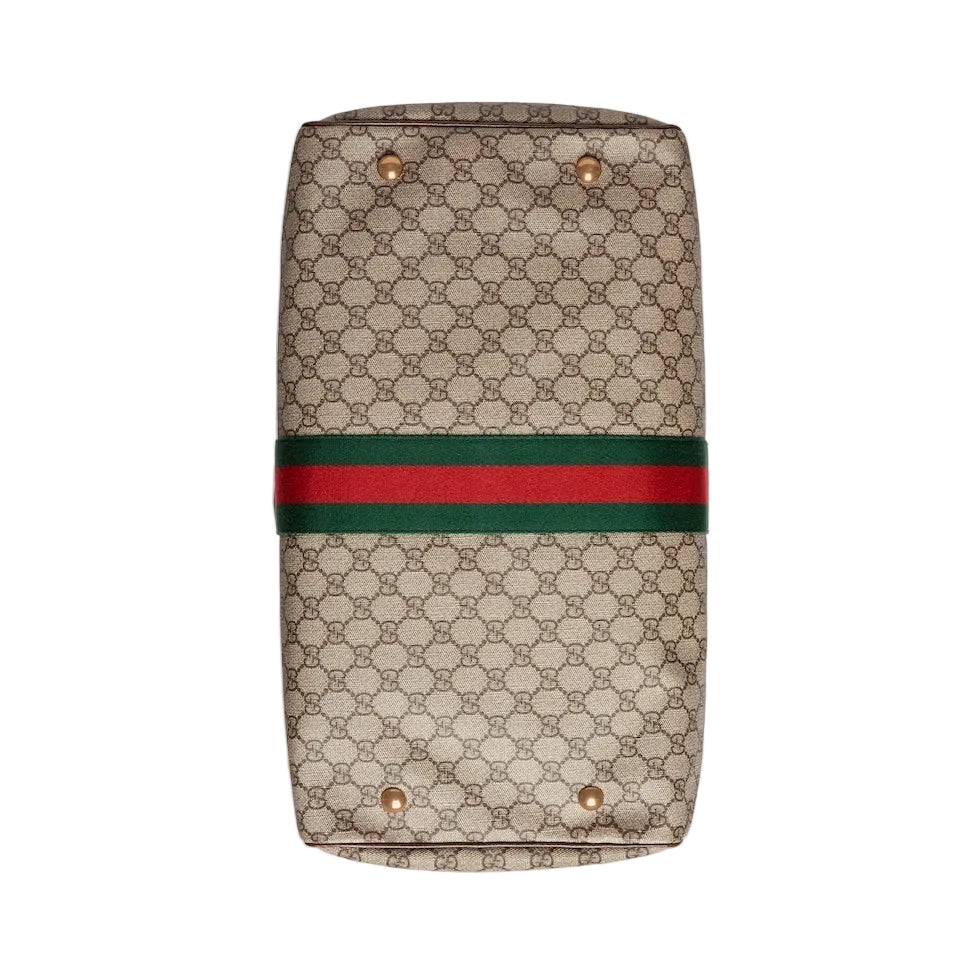 Beige handbag with a red and green stripe on a light gray background