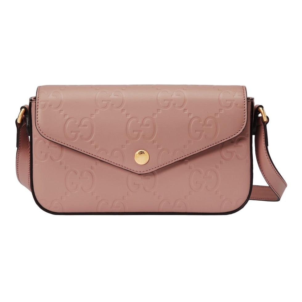 Pink handbag with gold accents on a light gray background
