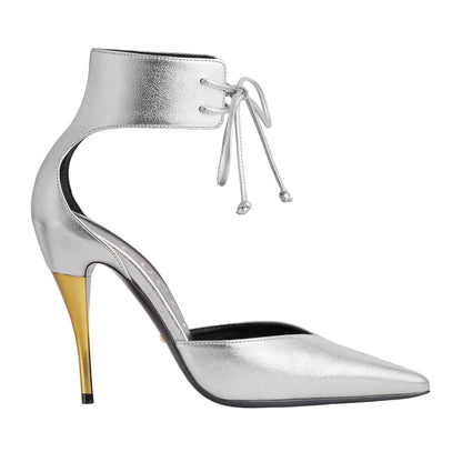 Silver high-heeled shoe with a gold heel on a light gray background
