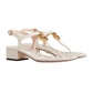 White sandal with gold accents on a light gray background