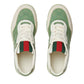 Green and white sneakers with red accents on a light gray background