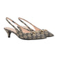 Pair of Gucci high heels with patterned design and gold accents on a light gray background