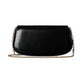 Black handbag with a chain detail on a light gray background