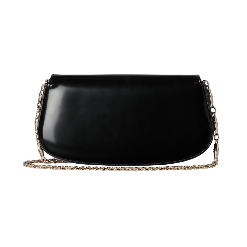Black handbag with a chain detail on a light gray background