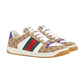 Beige Gucci sneakers with multicolor stripes on a light gray background
